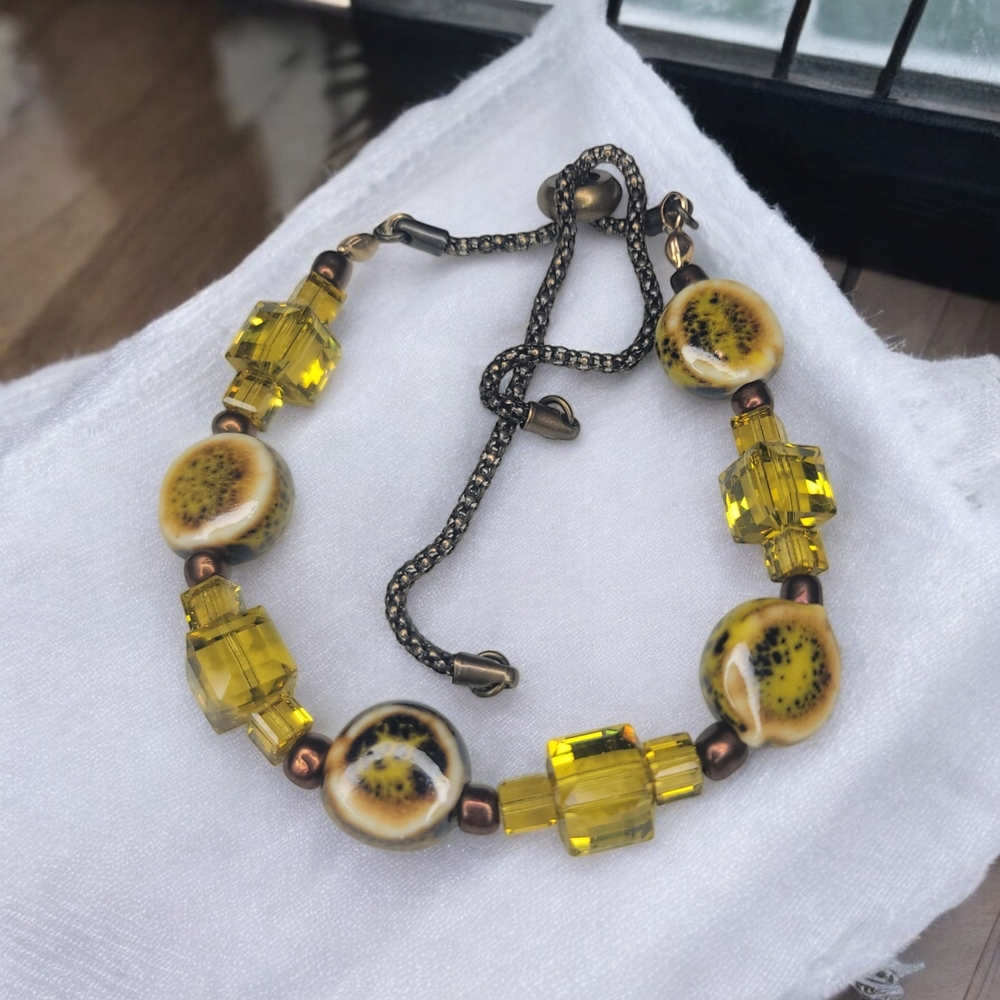 Artistic Yellow Bracelet with Unique Beads and Dark Metal Accents